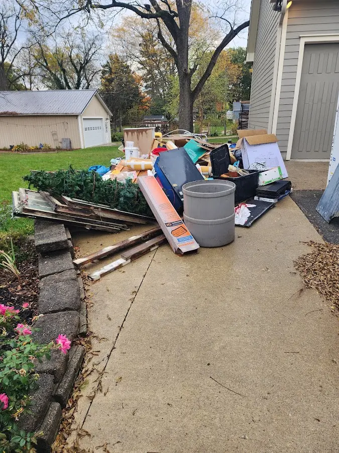Dumpster being loaded with debris for 10 Yard Dumpster Rental in Farmington
